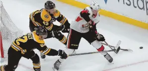  ?? STAFF PHOTO BY NANCY LANE ?? DOUBLE TEAM: Sean Kuraly (52) and Danton Heinen (43) battle with the Ottawa Senators’ Thomas Chabot for control of the puck during the third period of the Bruins’ 6-3 win Monday at the Garden.