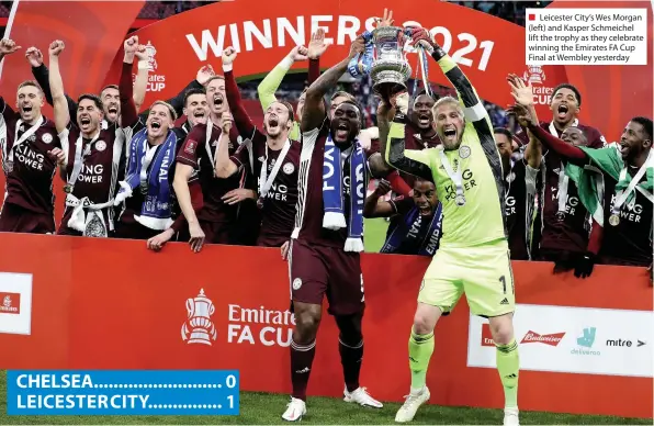  ??  ?? ■ Leicester City’s Wes Morgan (left) and Kasper Schmeichel lift the trophy as they celebrate winning the Emirates FA Cup Final at Wembley yesterday