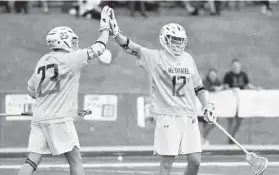  ?? PHOTOS BY BRIAN KRISTA/CARROLL COUNTY TIMES ?? McDaniel’s Nick DeLoriers, left, and Bryce Brookhart celebrate a goal Saturday.