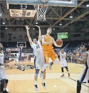  ?? SUBMITTED PHOTO ?? Brad States of the Island Storm, third left, goes up for layup against Jahmal McQueen of the Saint John Riptide in National Basketball League of Canada playoff action Sunday in Charlottet­own. Saint John won the game 107-97 to force a deciding Game 5 on...