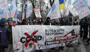  ?? Efrem Lukatsky / Associated Press ?? For the second time this month, protests erupt Wednesday after Ukrainian authoritie­s required teachers, government employees and other workers to get fully vaccinated against COVID-19.