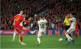  ?? Peter Powell/EPA ?? Kieffer Moore plants his shot low past the Belgium defence for Wales’s equaliser. Photograph: