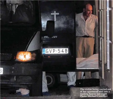  ?? Photo: Michael Camilleri ?? The victim being carried out of her apartment and into a waiting hearse last night