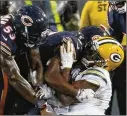  ?? AP ?? The Packers’ Davante Adams was taken off on a stretcher after being hit in the face and head by the helmet of Bears linebacker Danny Trevathan (59).