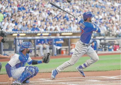  ??  ?? Third baseman Kris Bryant, who had three of the Cubs’ six hits Saturday against the Brewers, hits a single in the first inning. | AP