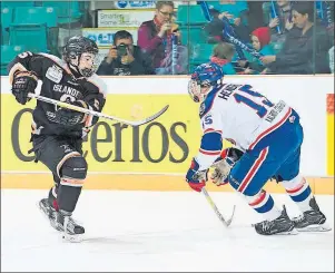  ?? MATTHEW MURNAGHAN/HOCKEY CANADA IMAGES ?? Ryan MacLellan, left, of the Cape Breton West Islanders tries to break around Parker Hendren of the Regina Pat Canadians during play at the 2017 Telus Cup national midget championsh­ip, Friday. Regina won the game 5-2.