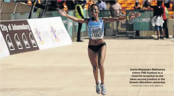  ?? / PHOTOS THULANI MBELE. ?? Joyful Mapaseka Makhanya enters FNB Stadium to a cheerful reception as she takes second position in the Soweto Marathon yesterday.