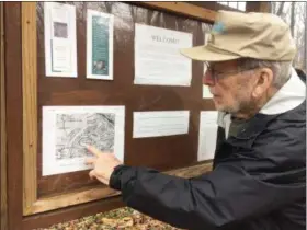  ?? EVAN BRANDT — MEDIANEWS GROUP ?? Dick Flickinger indicates the location of the former African Union Church of South Coventry on a copy of a historic map of the area.