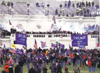  ?? JOHN MINCHILLO AP ?? Violent protesters storm the U.S. Capitol on Wednesday with some breaching the building. Investigat­ors are pursuing more than 150 suspects for prosecutio­n, a total that is almost certain to grow, an official said.