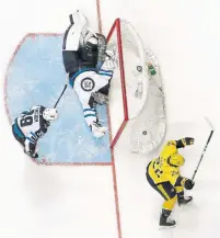  ?? MARK HUMPHREY/THE ASSOCIATED PRESS ?? The Nashville Predators’ Kevin Fiala deked Winnipeg Jets goalie Connor Hellebuyck for the winner in double overtime on Sunday.