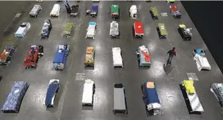  ?? AP ?? On Aug. 11, beds fill an emergency homeless shelter set up inside the San Diego Convention Center.