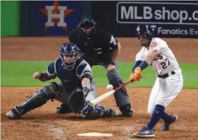  ?? Associated Press ?? Houston Astros’ Jose Altuve hits a home run during the eighth inning of Game 6 of baseball’s American League Championsh­ip Series against the New York Yankees on Friday in Houston.