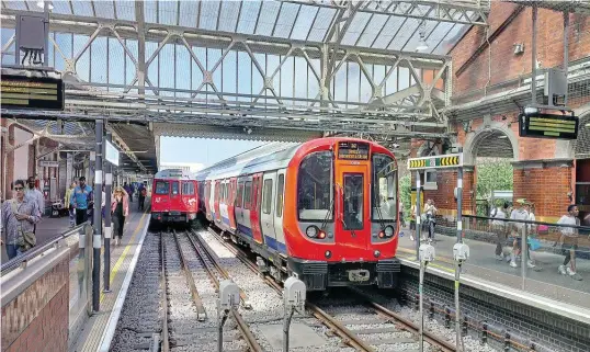  ??  ?? Automation-ready ‘S' Stock was introduced from 2010 and now operates on all Sub-Surface Lines. Driving car No. 21309 is pictured at Hammersmit­h on July 11, 2013, alongside a set of ‘C' Stock it replaced. Ccomley/Creative Commons