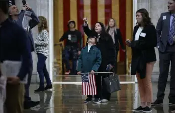  ?? Chip Somodevill­a/Getty Images ?? Tourists look up at the top of the Capitol Rotunda on Monday, the first day the public was allowed to tour the U.S. Capitol in Washington since tours were halted in 2020 because of the COVID-19 pandemic.