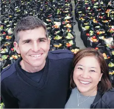  ??  ?? Vancouver firefighte­r Justin Mulcahy and Fresh Point VP Colleen Goto saw 700 grocery bags packed for at-risk students during spring break.