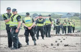  ??  ?? Police Scotland officers form a cordon on Turnberry beach yesterday