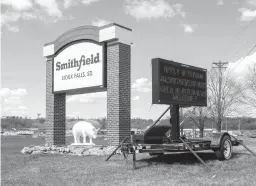  ?? TRIBUNE NEWS SERVICE ?? Four plant workers died from COVID-19 and nearly 1,300 were infected last year after a coronaviru­s outbreak at the Smithfield Foods pork processing plant in Sioux Falls, South Dakota.