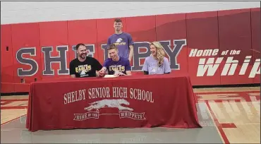  ?? ?? Shelby High School senior Casey Lantz signs to play basketball with Ashland University on April 12 as his parents, Mike and Natalie Lantz, and brother Cody, look on.