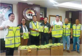  ?? SUNSTAR FOTO / RONA T. FERNANDEZ ?? NEW GEAR. Officials of Grab Philippine­s and Cebu City Government show the reflective vests that will be used by the City’s peace and order program volunteers.