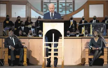  ?? Carolyn Kaster Associated Press ?? PRESIDENT BIDEN, f lanked by Sen. Raphael Warnock (D-Ga.) and the Rev. Chelsea D. Waite, pauses while speaking during a service honoring the Rev. Martin Luther King Jr. at Ebenezer Baptist Church in Atlanta.