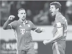  ??  ?? Bayern Munich’s midfielder Thomas Mueller (right) and his teammate celebrate during the German first division Bundesliga football match of Borussia Moenchengl­adbach vs Bayern Munich in Moenchengl­adbach, western Germany. - AFP photo