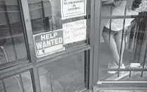  ?? Callaghan O’Hare / Bloomberg ?? A “help wanted” sign hangs outside a restaurant in Houston in April. Hiring remains robust though some companies say they can’t find enough employees to fill their open positions.