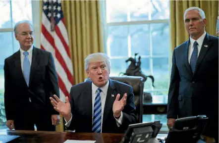  ??  ?? US President Donald Trump, accompanie­d by Health and Human Services Secretary Tom Price, left, and Vice President Mike Pence, talks to the media at the Oval Office after the healthcare reform bill was pulled before a vote.