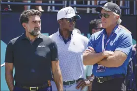  ?? Associated Press ?? Yasir Al-Rumayyan (left), governor of Saudi Arabia’s Public Investment Fund, Majed Al-Sorour, CEO of Golf Saudi (center) and Greg Norman, CEO of LIV Golf, watch at the first tee during the second round of the Bedminster Invitation­al LIV Golf tournament on July 30 in Bedminster, N.J.