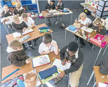  ?? We all know what happens when a child is given a project to complete. The child takes it home and mom and dad do a superb job and they are bitterly disappoint­ed when they only get 95% ?? Pupils at Woodridge Preparator­y in Port Elizabeth busy in class. But when the home bell rings, it’s time to play.