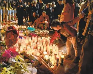  ?? Wally Skalij Los Angeles Times ?? MOURNERS PARTICIPAT­E in a vigil on Tuesday for the victims of the mass shooting on Lunar New Year’s Eve at the Star Ballroom Dance Studio in Monterey Park.