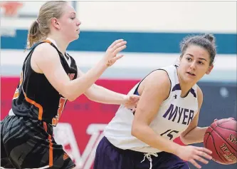  ?? JULIE JOCSAK THE ST. CATHARINES STANDARD ?? Ridley College’s Hassait Hilawe defends A.N. Myer’s Tori Rigas-DiDomenico at the Tribune Girls Basketball Tournament Wednesday in Welland.