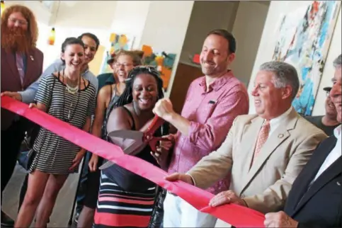  ?? LAUREN HALLIGAN — LHALLIGAN@DIGITALFIR­STMEDIA.COM ?? Owner Jeremy Cowan and manager Kamri Haynes cut the ribbon on the new 518 Craft and The Shmaltz Shop.