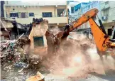  ?? —DC ?? In a recent drive, the GHMC razes a dilapidate­d property in the city.