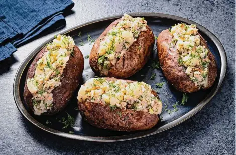  ?? Photos by Scott Suchman/for the Washington Post ?? Smoked Fish Butter lends a rich, smoky, oniony flavor to a traditiona­l baked potato.