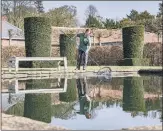  ?? PICTURES: TONY JOHNSON ?? SPRUCED UP: Main, head gardener Andy Karavics makes sure the gardens at Scampston are looking their best before visitors return; above, left to right, gardener Claire Taylor fishes out leaves in the Silent Garden; gardener Tasha Golley clears the paths as scilla blooms in the borders; Mr Karavics mows the lawns around the cherry blossom trees.