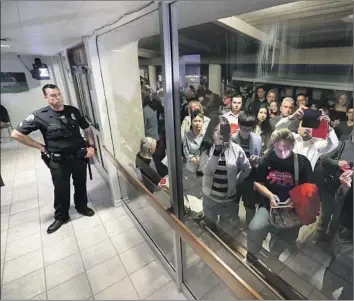  ?? Robert Gauthier Los Angeles Times ?? DOZENS watch from the patio of Los Alamitos City Hall during Monday’s council meeting and vote.