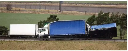  ??  ?? BLOWN OVER: Lorries block road after being toppled by gales on the A1 near Skateraw in East Lothian