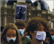  ?? MICHEL SPINGLER — THE ASSOCIATED PRESS ?? A portrait of Samuel Paty is held up as people gather on Republique square in Lille, northern France, on Sunday.