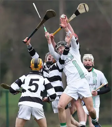  ??  ?? Ted Drea of St. Kieran’s wins this battle in the air with Kyle Firman during Saturday’s clash in Fenagh.