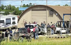  ?? NWA Democrat-Gazette/BEN GOFF ?? Search teams gather at a staging area Monday on U.S. 412 near Hindsville in Madison County. Multiple agencies and volunteers spent the day searching for two children who were lost when their mother’s vehicle was swept off a low-water bridge Saturday....