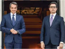  ?? ?? Greek Prime Minister Kyriakos Mitsotakis (l) welcomes North Macedonia’s President Stevo Pendarovsk­i ahead of their meeting at Maximos Mansion on October 5.