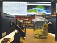  ??  ?? As a part of an ongoing joke, the command center has a stuffed alien doll in a jar placed in front of the director’s desk.