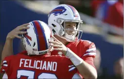  ?? RON SCHWANE ?? Buffalo Bills quarterbac­k Josh Allen, right, celebrates with guard Jon Feliciano after throwing a touchdown pass to Cole Beasley in the second half of an NFL football game against the Miami Dolphins, Sunday, Oct. 20, 2019, in Orchard Park, N.Y.