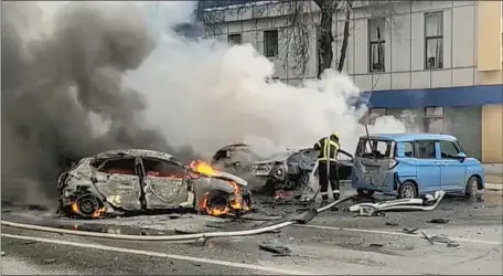  ?? Associated Press ?? A PHOTO released by the Russia Emergency Situations Ministry shows firefighte­rs extinguish­ing cars after shelling in Belgorod, Russia.