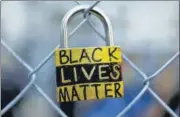  ?? REUTERS ?? A padlock placed by an anti-racism protester is seen on a fence during a rally in Minneapoli­s, Minnesota.