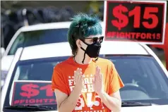  ?? JOHN RAOUX — THE ASSOCIATED PRESS ?? Cristian Cardona, an employee at a McDonald’s, attends a rally for a $15an hour minimum wage Tuesday in Orlando, Fla.