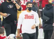  ?? RANDY VAZQUEZ — BAY AREA NEWS GROUP ?? 49ers quarterbac­k Jimmy Garoppolo walks around the bench as his team plays the Eagles at Levi’s Stadium in Santa Clara on Sunday.