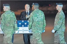  ?? [CLIFF OWEN/ THE ASSOCIATED PRESS] ?? Members of the Army move a transfer case containing the remains of Sgt. 1st Class Elis Barreto Ortiz, 34, from Morovis, Puerto Rico, past Secretary of State Mike Pompeo, Saturday at Dover Air Force Base, Del.