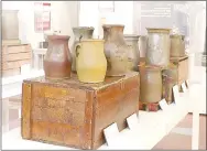  ?? FILE PHOTO ?? An exhibit on 19th century potters of Northwest Arkansas featured J.D. Wilbur, a master potter who arrived in Boonsboro (now Cane Hill) in 1868. The pottery in the foreground are some pieces that were on display in the exhibit.