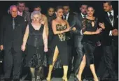  ?? EITAN ABRAMOVICH / AGENCE FRANCE-PRESSE ?? Dancers Oscar Brusco (left) and Nina Chudoba (second left) walk to the stage during the Tango World Championsh­ip in Buenos Aires, Argentina, last week.